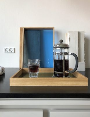 French press coffee maker on tray with glasses