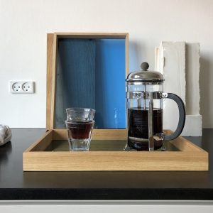 French press coffee maker on tray with glasses
